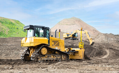 Bulldozer and excavator on the construction site