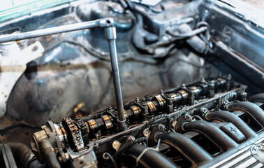 car engine repair, camshaft valve adjustment.