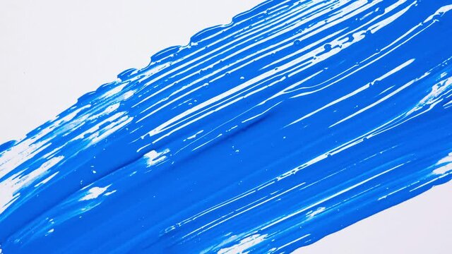 Close up of artist holding paint brush and drawing gouache painting. Painting blue squares on canvas. 4k resolution video