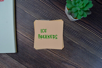Ice Breakers write on sticky notes isolated on Wooden Table. - obrazy, fototapety, plakaty