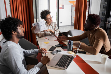 Group of smiling diverse colleagues discussing together project ideas in room