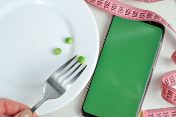 Smartphone with green screen and fresh vegetables copy space