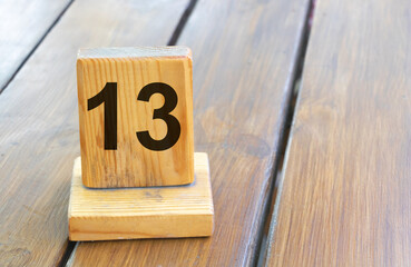 Wooden priority number 13 on a plank tab