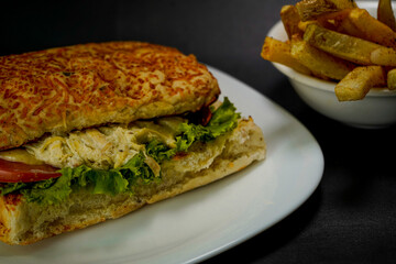 Delicious chicken sandwich on black background
