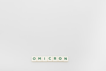 Fototapeta premium top view of white cubes with omicron lettering on grey background with copy space.