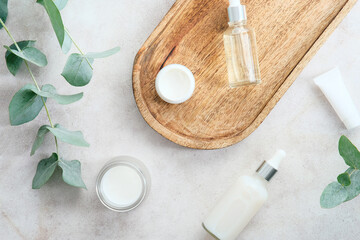 Natural skin care cosmetics and eucalyptus leaves on stone table. SPA organic beauty products set.
