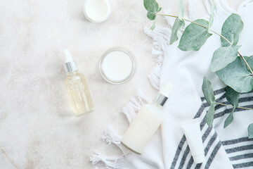 Obraz na płótnie Canvas Beauty SPA cosmetics and eucalyptus leaves on stone table. Skincare concept.