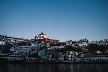 Fototapeta premium Top view of the Dom Luis I Bridge across the Douro River and Vila Nova de Gaia banks, Portugal.