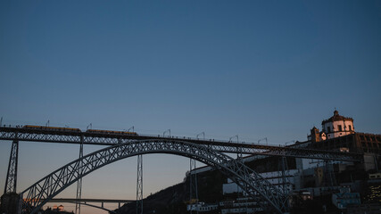 Silhouette of Dom Luis I Bridge at night in the center of the old city of Porto, Portugal.