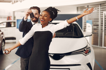 Elegant couple in a car salon