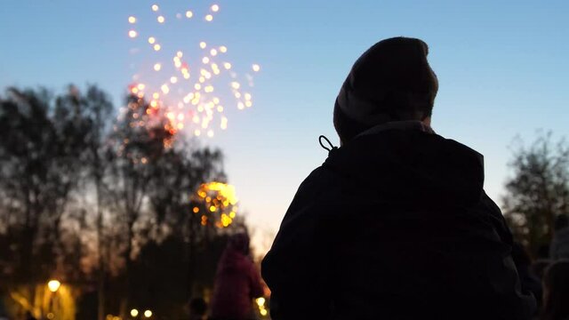 family look at the sky at the fireworks. The night sky in lights
