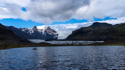 Beautiful Cinematic Aerial view of the massive Svinafellsjokull Glacier in Iceland and its lagoon caused by global warming