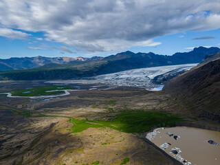 Fototapeta na wymiar Beautiful Cinematic Aerial view of the massive Svinafellsjokull Glacier in Iceland and its lagoon caused by global warming