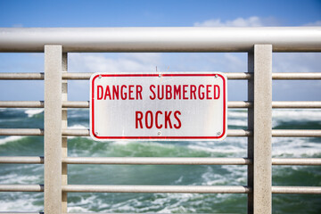 Danger Submerged rocks on safety railing