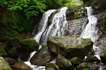 Naklejka na ściany i meble trekking around waterfall in summer