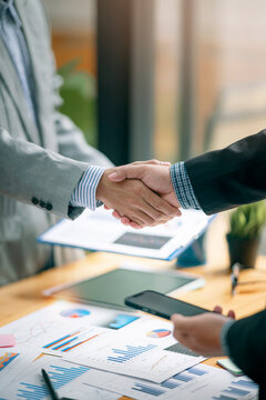 Two Businessman handshake for teamwork of business merger and acquisition at office.