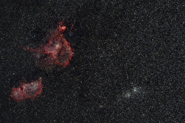 red glowing heart and soul nebula with open double star cluster in perseus