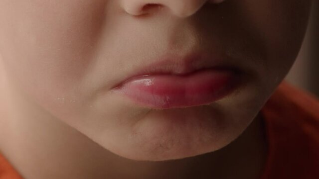 Close up of a little boy's pouting lips and mouth.