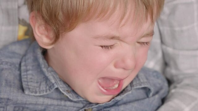 Toddler boy upset and crying.