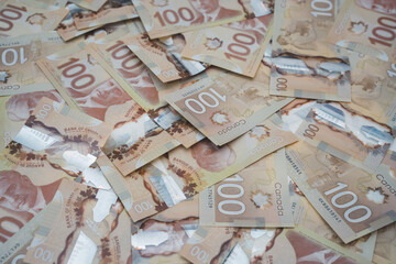 Scattered Canadian $100 Banknotes