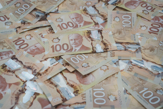 Canadian currency banknotes background with one hundred dollar bills