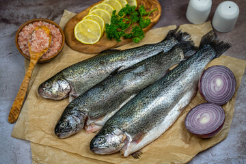 Three raw trout ready to be cooked.