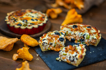Mushroom pie with chanterelles lying on a wooden background
