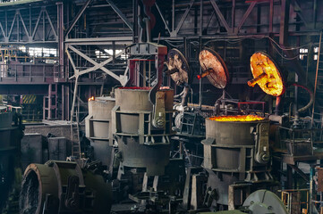 Fototapeta na wymiar Metallurgical production. Melting of metal in an open-hearth furnace.