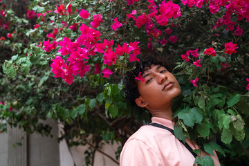 Portrait of an attractive and stylish fashionable young Latin American non-binary teenage girl, confident and happy with her gender identity, outdoors