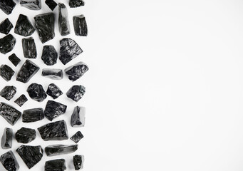 Obsidian crystal stone flat lay on white background