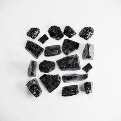 Obsidian crystal stone flat lay on white background