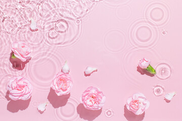 Water background. Pink aqua texture, surface of ripples, transparent, flower, shadows and sunlight....