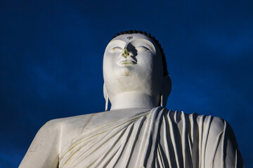 Huge Buddha statue Korathota Raja Maha Viharaya is under dark sky