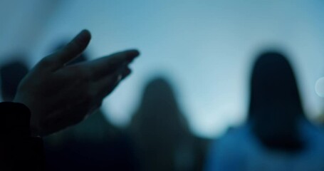 Christian Person Prays at Worship and Praise Night. Religious Music Event with Crowds of People, Concert Stage and Lights. 4K background handheld shot in slow motion