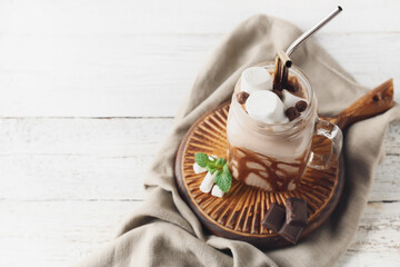 Mason jar of sweet cocoa drink on table