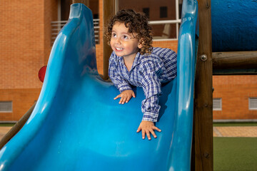 Cute little boy playing happily in the park