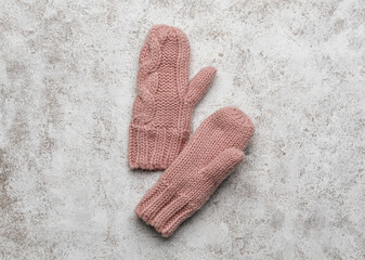 Pair of warm mittens on light background