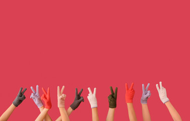 Women in warm gloves showing OK gesture on color background