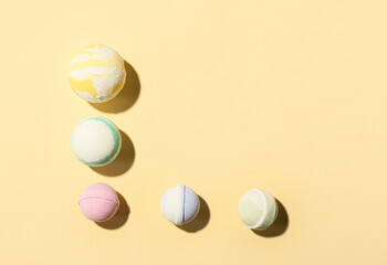 Different bath bombs on color background