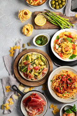 Pasta assortment on gray background.
