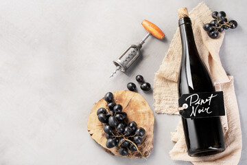 Red wine assortment with appetizers on light gray background.