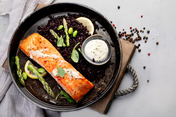 Baked salmon with asparagus and black rice.