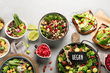 Vegan dishes assortment on gray background.