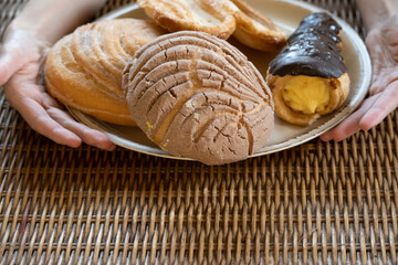 Unrecognizable woman offering traditional Mexican bread dish