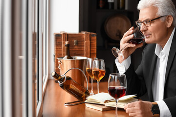 Mature sommelier tasting types of wine