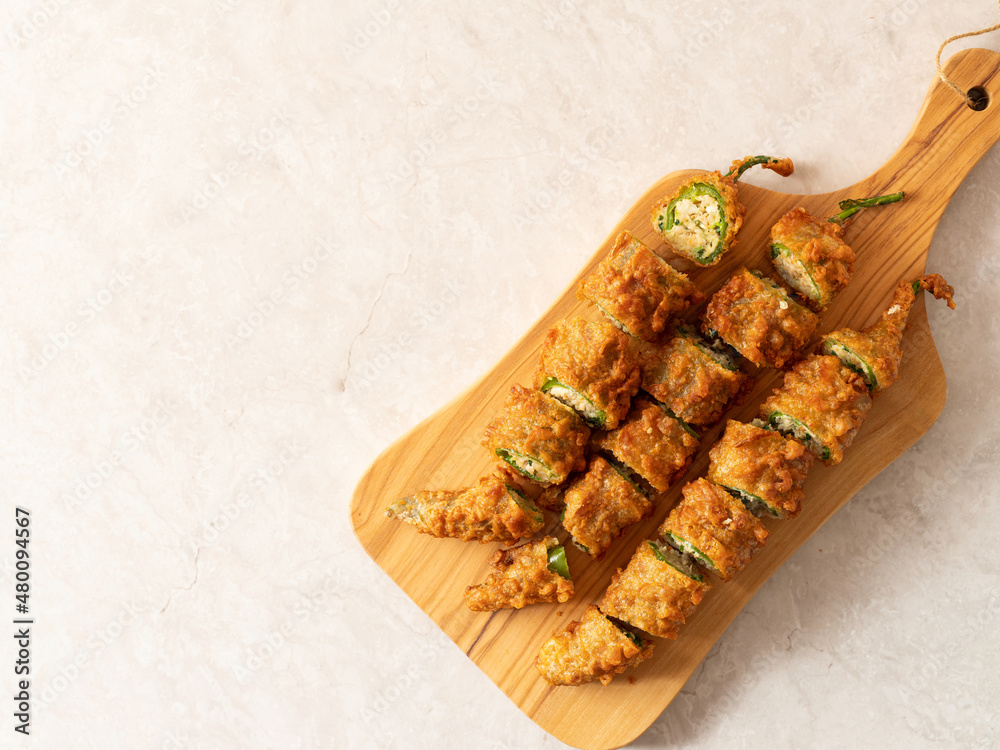 Poster fried chilli pepper stuffed minced meat and vegetables