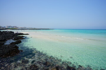 a shoaling beach with crystal-clear water