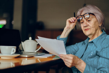 elderly woman working in front of laptop monitor sitting Lifestyle unaltered