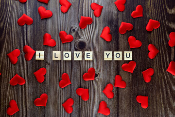 The inscription I love you on a wooden background. View from above. Valentine's Day