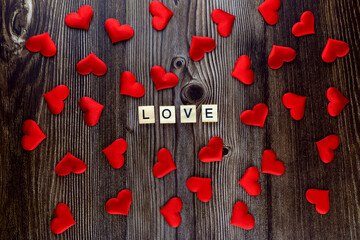The inscription love on a wooden background. View from above. Valentine's Day